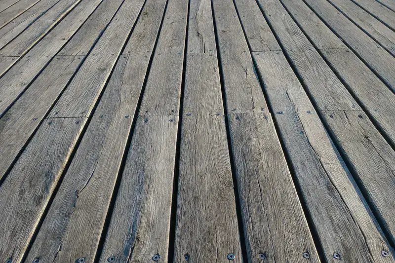 Before: weathered grey wood boards